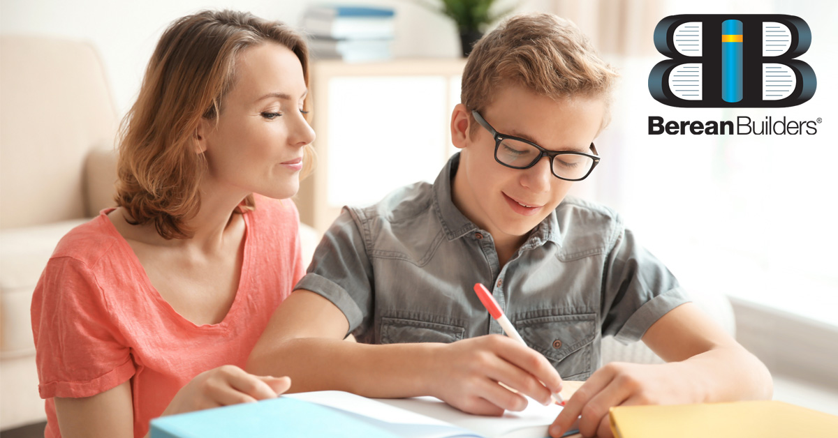 Mother and son working at table